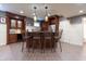 Finished basement wet bar with custom cabinets, granite counters, barstool seating and stainless refrigerator at 876 Box Turtle Ct, Columbus, IN 47201