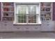 Charming window seat with storage and built-in bookshelves creates a cozy reading nook with natural light and a view at 876 Box Turtle Ct, Columbus, IN 47201
