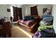 This bedroom has a queen bed and a large window with brown curtains at 8936 E 46Th St, Indianapolis, IN 46226