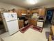 Traditional kitchen with oak cabinets, gas range, and white refrigerator at 8936 E 46Th St, Indianapolis, IN 46226