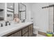 Bathroom featuring double vanity, stylish mirrors and lighting, and modern fixtures at 9229 Crossing Dr, Fishers, IN 46037