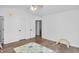Bright, airy bedroom with hardwood floors, and view to ensuite bathroom at 9229 Crossing Dr, Fishers, IN 46037