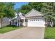 Charming two-story home with a well-manicured lawn, two-car garage, and inviting entrance at 9229 Crossing Dr, Fishers, IN 46037