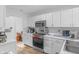 Well-lit kitchen showcases modern appliances, white cabinetry, and functional design elements at 9229 Crossing Dr, Fishers, IN 46037