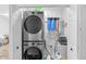 Functional laundry room featuring stacked washer and dryer, along with storage solutions at 9229 Crossing Dr, Fishers, IN 46037