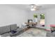 Cozy living area with comfortable seating, ceiling fan, and french doors leading to the outside at 9229 Crossing Dr, Fishers, IN 46037