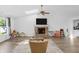 Bright and spacious living room with hardwood floors, brick fireplace, and skylights, perfect for relaxing and entertaining at 9229 Crossing Dr, Fishers, IN 46037