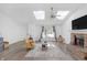 Bright living room features hardwood floors, skylights, and a brick fireplace, offering a comfortable and inviting atmosphere at 9229 Crossing Dr, Fishers, IN 46037