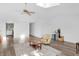 A large and well-lit living room boasts hardwood floors, a ceiling fan, and easy access to the kitchen for seamless entertaining at 9229 Crossing Dr, Fishers, IN 46037