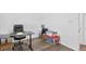 Bright room featuring a desk and chair, wood-look floors, and storage at 9229 Crossing Dr, Fishers, IN 46037