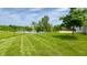 A lush green lawn leads to a serene lake, all enclosed by a sleek black fence at 994 Young'S Creek Dr, Franklin, IN 46131