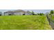 Large, well-manicured backyard with black chain link fence at 994 Young'S Creek Dr, Franklin, IN 46131