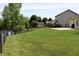 Large, grassy backyard featuring a fence, patio, and access to a lush green space at 994 Young'S Creek Dr, Franklin, IN 46131