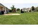 Spacious backyard with a concrete patio, lush green lawn, and secure black fence at 994 Young'S Creek Dr, Franklin, IN 46131