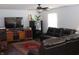 Comfortable living room with dark leather couches, a ceiling fan, and a TV at 994 Young'S Creek Dr, Franklin, IN 46131