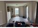 Bright dining room featuring modern lighting, with an view to the backyard at 10803 Gathering Dr, Indianapolis, IN 46259