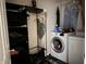 Efficient laundry area equipped with modern washer and dryer, and convenient storage options at 10803 Gathering Dr, Indianapolis, IN 46259