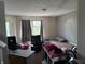 Comfortable living room with a large window, and carpeted floors at 10803 Gathering Dr, Indianapolis, IN 46259