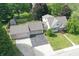 Aerial shot of a charming home with a large driveway and a two-car garage surrounded by lush greenery at 1101 E Loretta Dr, Indianapolis, IN 46227