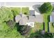 Overhead view of a house with a deck, surrounded by mature trees and a well-maintained landscape at 1101 E Loretta Dr, Indianapolis, IN 46227