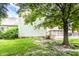 Grassy backyard showcasing the home's exterior and a wooden deck, perfect for outdoor living at 1101 E Loretta Dr, Indianapolis, IN 46227