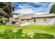 Expansive backyard featuring a wooden deck, lush lawn, and the rear exterior of the home at 1101 E Loretta Dr, Indianapolis, IN 46227
