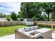 Well-maintained backyard featuring a wooden deck with patio furniture, a shed, and lush greenery at 1101 E Loretta Dr, Indianapolis, IN 46227