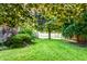 Serene backyard with lush green lawn, privacy fence, and mature trees, creating a peaceful retreat at 1101 E Loretta Dr, Indianapolis, IN 46227