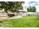 Large backyard with a wooden deck, green lawn, and a privacy fence, great for outdoor activities at 1101 E Loretta Dr, Indianapolis, IN 46227
