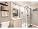 Updated bathroom with tiled shower, modern vanity, sleek fixtures and wood look flooring at 1101 E Loretta Dr, Indianapolis, IN 46227