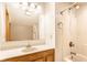 Bright bathroom featuring a vanity with a large mirror and a shower with white tiling at 1101 E Loretta Dr, Indianapolis, IN 46227