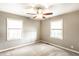 Neutral bedroom with carpet, two windows letting in lots of natural light, ceiling fan at 1101 E Loretta Dr, Indianapolis, IN 46227