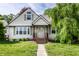 Close-up of cozy single-story home featuring a charming front porch with stained wooden steps and columns at 1101 E Loretta Dr, Indianapolis, IN 46227