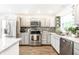 Modern kitchen with gray cabinets, stainless steel appliances, granite countertops and tile backsplash at 1101 E Loretta Dr, Indianapolis, IN 46227