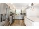 Updated kitchen featuring stainless steel appliances, granite countertops, gray cabinets and an island at 1101 E Loretta Dr, Indianapolis, IN 46227