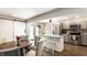 Well-lit kitchen featuring gray cabinets, a dining table, an island and stainless steel appliances at 1101 E Loretta Dr, Indianapolis, IN 46227