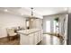 Open kitchen and dining area with island, barn door, stainless appliances and modern finishes at 1101 E Loretta Dr, Indianapolis, IN 46227