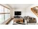 Bright living room featuring two sofas, a large window, a TV on a stand and neutral walls at 1101 E Loretta Dr, Indianapolis, IN 46227