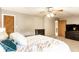 Carpeted main bedroom with large bed, ceiling fan, and lots of storage at 1101 E Loretta Dr, Indianapolis, IN 46227