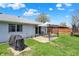 Backyard featuring a patio with pergola, white brick exterior, green lawn, and wooden fence at 1111 Cambridge Dr, Greenwood, IN 46142