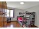 Cozy bedroom with a bunk bed, wood floors, and a window at 1111 Cambridge Dr, Greenwood, IN 46142
