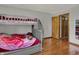Bedroom with bunkbeds, wooden floors, and hall closet at 1111 Cambridge Dr, Greenwood, IN 46142