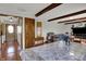 Open dining area with hardwood floors, wooden beams, and adjacent access to other rooms at 1111 Cambridge Dr, Greenwood, IN 46142