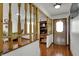 Inviting entryway featuring hardwood floors and a decorative wood railing, enhancing the home's character at 1111 Cambridge Dr, Greenwood, IN 46142