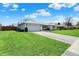 Well-maintained white brick house with an attached garage and a lush green lawn at 1111 Cambridge Dr, Greenwood, IN 46142