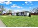 Attractive white brick home with neat landscaping, a spacious lawn, and an attached garage at 1111 Cambridge Dr, Greenwood, IN 46142