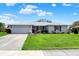 Charming single-story home with white brick, red shutters, and a well-manicured lawn at 1111 Cambridge Dr, Greenwood, IN 46142