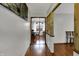 Hallway with hardwood floors leading to a dining area, showcasing the home's open layout at 1111 Cambridge Dr, Greenwood, IN 46142