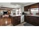 Spacious kitchen area with dark wood cabinets, an open layout, and access to the dining and living spaces at 1111 Cambridge Dr, Greenwood, IN 46142