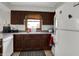 Functional kitchen space featuring wooden cabinetry and essential appliances for convenient cooking at 1111 Cambridge Dr, Greenwood, IN 46142
